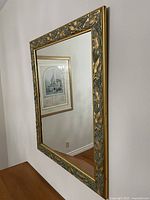 Front angled view of framed mirror on wall