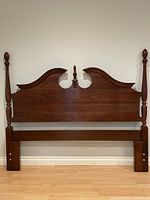 Full front view of cherry headboard with posts