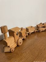 Locomotive, box car, freight cars linked on tabletop