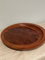 Top view of round teak tray showing staved pattern