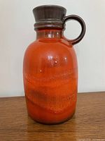 Front view showing red-orange glaze and shape