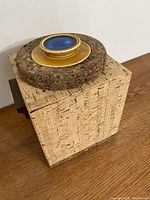 Top view showing cork lid and ceramic blue/gold accent