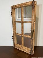 Full view of reclaimed window frame mirror standing upright
