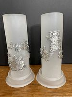 Both frosted glass hurricanes with pewter decorations on bases