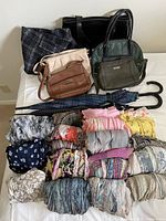 Group view of rolled scarves, purses, umbrellas