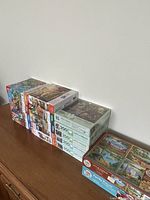 Stacked view of boxed puzzles on cabinet