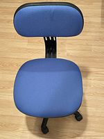 Top view of blue fabric seat and backrest on rolling chair