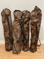 Four camo carry bags upright