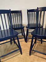 All four navy blue children’s chairs in a group