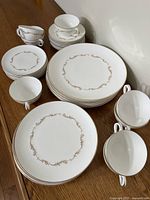 Stacks of dinner, salad, side plates, teacups and saucers showing pattern