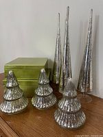 all items grouped: six mercury-glass tree ornaments and two green boxes