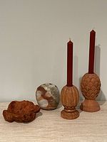 Group shot of burl bowl, pottery vase, two carved candlesticks