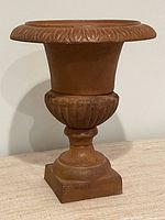 Front view of cast iron urn showing overall shape and finish