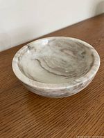 Angled view of marble bowl showing interior and color tones