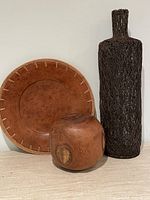 Group shot showing teak sphere, terracotta plate, wire vase