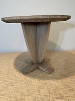 Overall view of round teak end table weathered finish