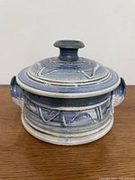 Front view of signed Wayne Cardinalli stoneware casserole with lid on