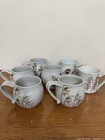 Seven Joseph Panacci mugs, layout shows five rounded, two straight forms