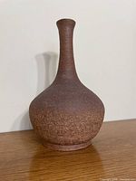 Front view of brown stoneware vase showing overall shape and texture