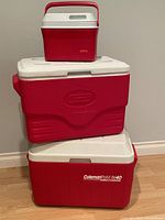 Three red/white coolers stacked to show sizes and brands