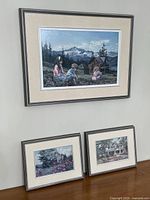 All three framed prints on wall and surface