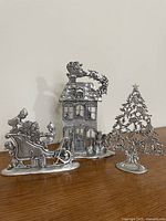 All three Seagull pewter Christmas figurines on table