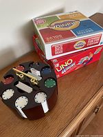 Overall lot showing poker carousel, Cranium box, Uno Extreme box