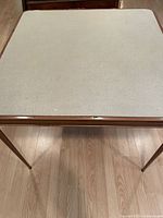 Full view of folding card table showing top and legs