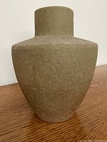 Front view of textured tan stoneware vase