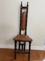 Front view of tall spindle-back prayer chair