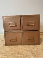 Front view of two stacked copper-finish card catalog units with closed drawers
