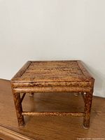 Top view of burnt bamboo stool showing slatted surface and mottled pattern