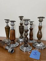 Front view of six complete candlesticks and separate stem