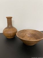 Walnut bowl and pottery vase side by side