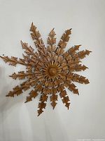 Front view of full carved wood sunflower-starburst wall hanging