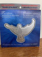 Front of retail sleeve showing product name and dove outline