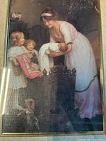 Close-up of the print showing the Victorian nursery scene with a woman holding a baby, two children, and a dog.