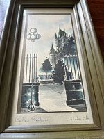 Full view of framed watercolor painting showing wrought iron gate and Château Frontenac in the background, signed and dated 1970
