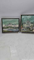 Two framed paintings on canvas showing views of the Philadelphia Art Museum, displayed side by side.