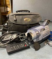 Sony Digital8 camcorder with lens cap on, remote, power cord, and Lowepro bag in background.