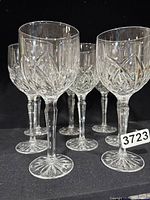 Set of eight Waterford Crystal Marquis Brookside vintage wine goblets showing detailed cut crystal patterns on black background.
