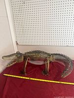 Full side view of metal alligator ornament