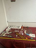 Overall view of assorted collectibles spread on red cloth