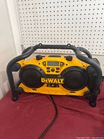 Front view of DeWalt DC011 radio-charger showing speakers, control panel and protective frame
