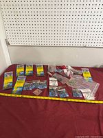 Lot layout showing all hook packs, loose bags, bobbers, measuring tape for scale