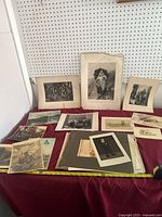 Overall lot view showing all mounted prints and loose photographs