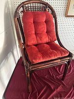 Front three-quarter view of rattan armchair with cushions