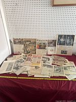 Overview of multiple vintage advertisement pages on table