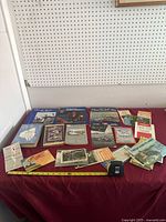 Overall view of table with all books, brochures and postcards