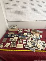 Overall lot showing photographs and postcards spread on table